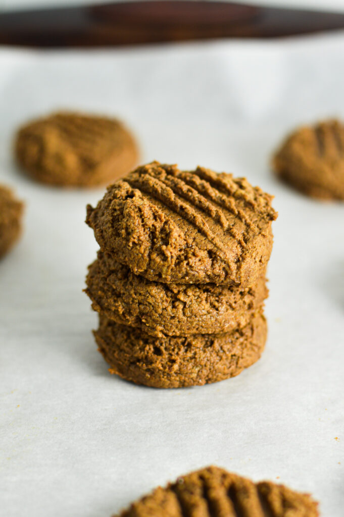 3 Peanut Butter Mocha Protein Cookies stacked with fork marks on the top.