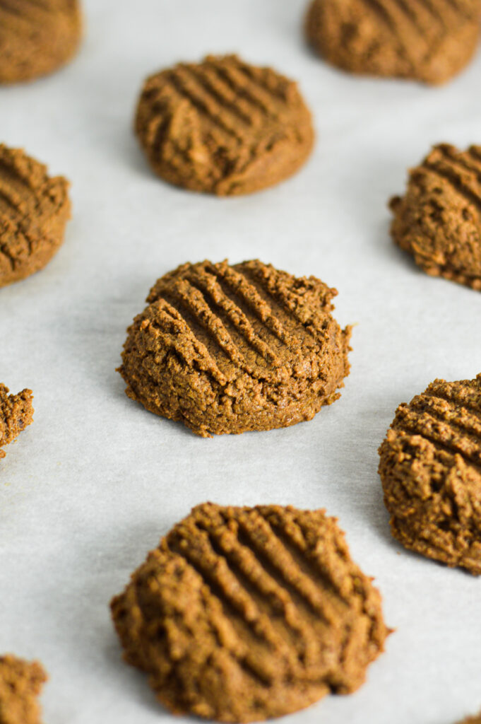 Peanut Butter Mocha Protein Cookies on a parchment paper lined baking sheet.