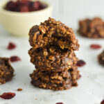 No Bake Nutella Cranberry Oatmeal Cookies arranged in a stack on a granite surface.