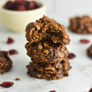 No Bake Nutella Cranberry Oatmeal Cookies arranged in a stack on a granite surface.