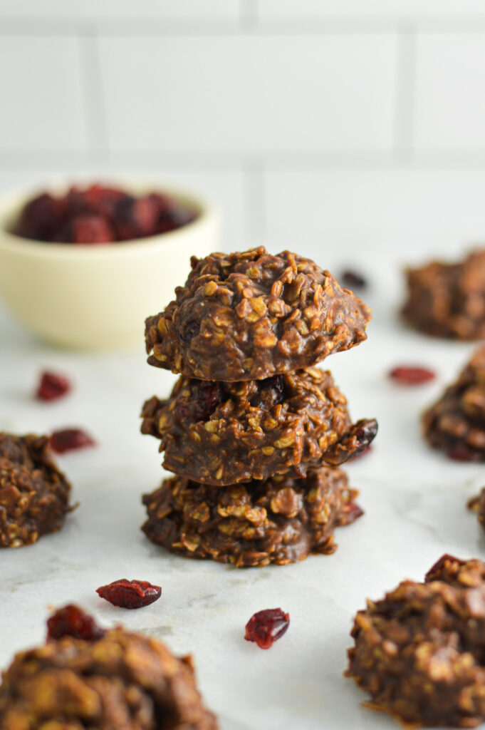 A stack of No Bake Nutella Cranberry Oatmeal Cookies. The oats create a rustic look, while the Nutella gives the cookies a glossy finish.