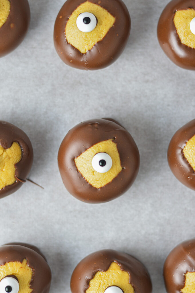 Some Eyeball Buckeyes on a parchment paper lined baking sheet.