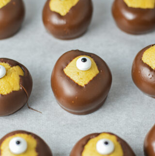 Some Eyeball Buckeyes on a parchment paper lined cookie sheet.