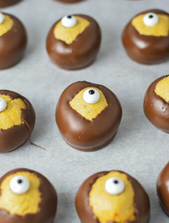 Some Eyeball Buckeyes on a parchment paper lined cookie sheet.