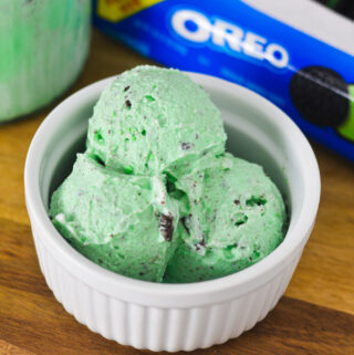 A white ramekin filled with scoops of pale green Ninja Creami Mint Oreo Ice Cream.