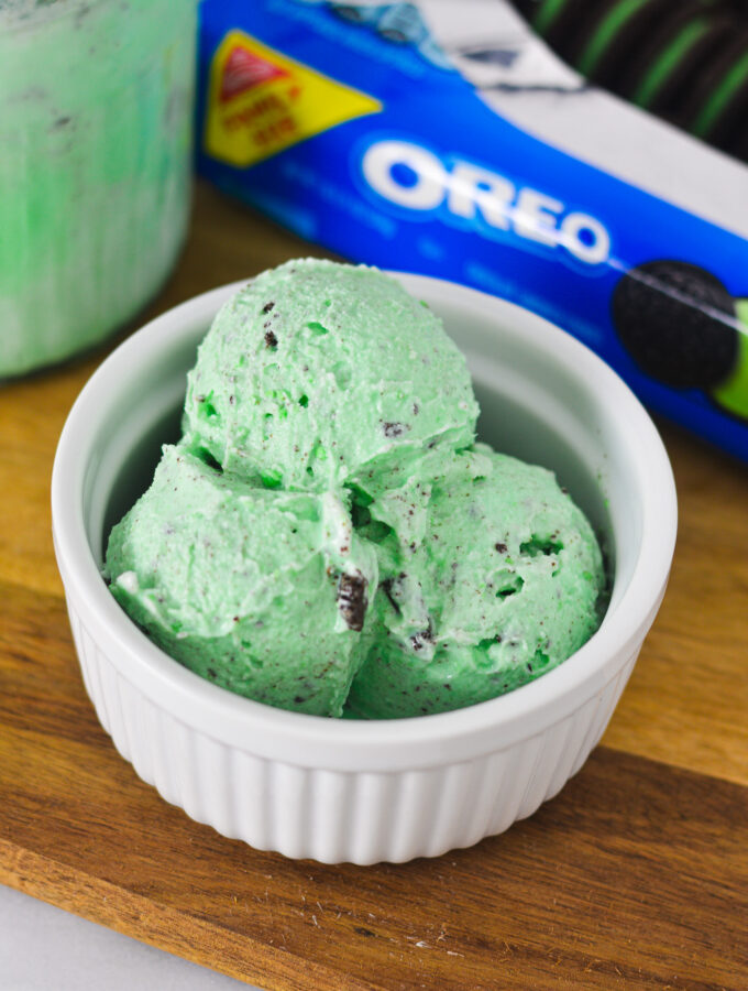 A white ramekin filled with scoops of pale green Ninja Creami Mint Oreo Ice Cream.