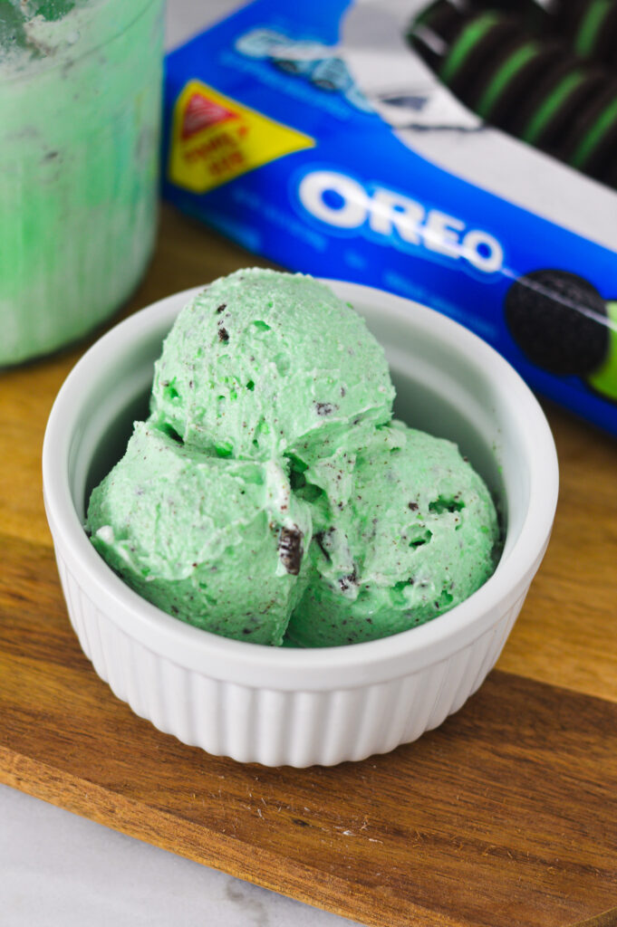 A white ramekin filled with scoops of pale green Ninja Creami Mint Oreo Ice Cream.