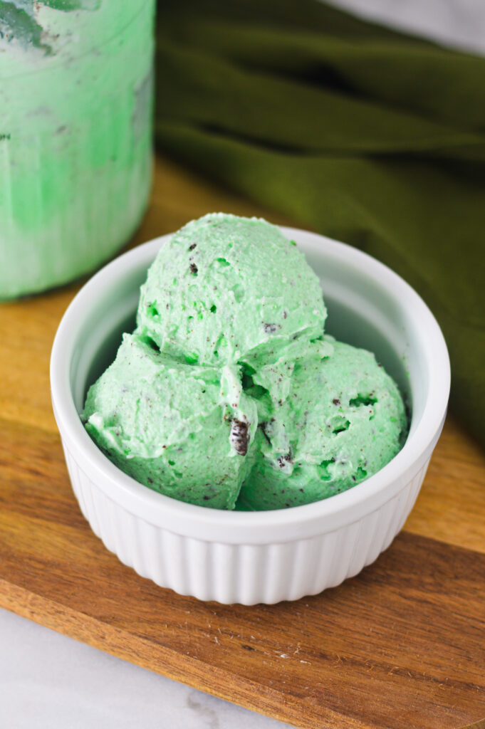 A bowl of vibrant green Ninja Creami Mint Oreo Ice Cream, with generous chunks of Oreo cookies in the ice cream.