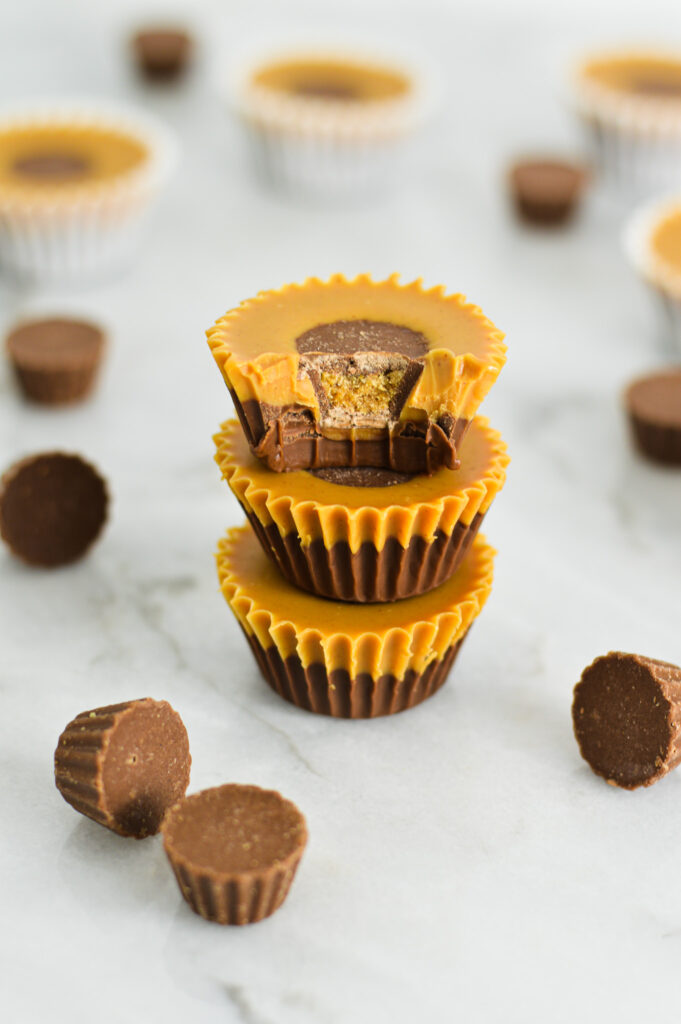 Reese's Peanut Butter Nutella Cups with a bite taken out of the top cup, revealing the smooth and decadent Nutella and Peanut Butter inside.