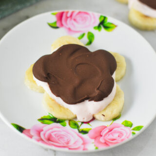 A Mini Chocolate Banana Yogurt Bark in the shape of a flower on a small plate.