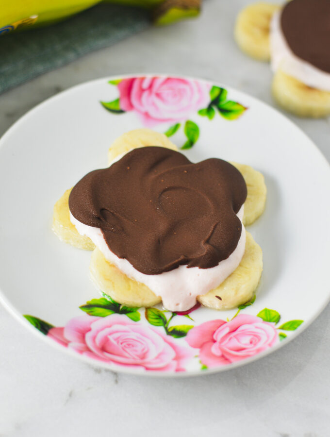 A Mini Chocolate Banana Yogurt Bark in the shape of a flower on a small plate.