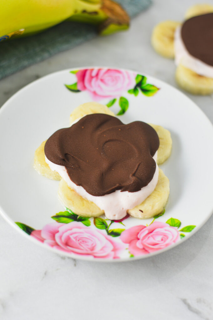 A Mini Chocolate Banana Yogurt Bark in the shape of a flower on a small plate.