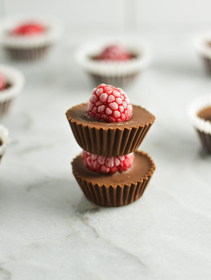 A stack of mini Raspberry Nutella Cups, with the red raspberries all frosty from being in the freezer.