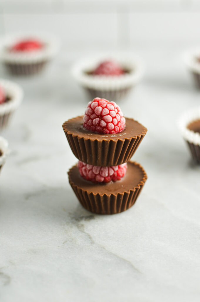 A stack of mini Raspberry Nutella Cups, with the red raspberries all frosty from being in the freezer.