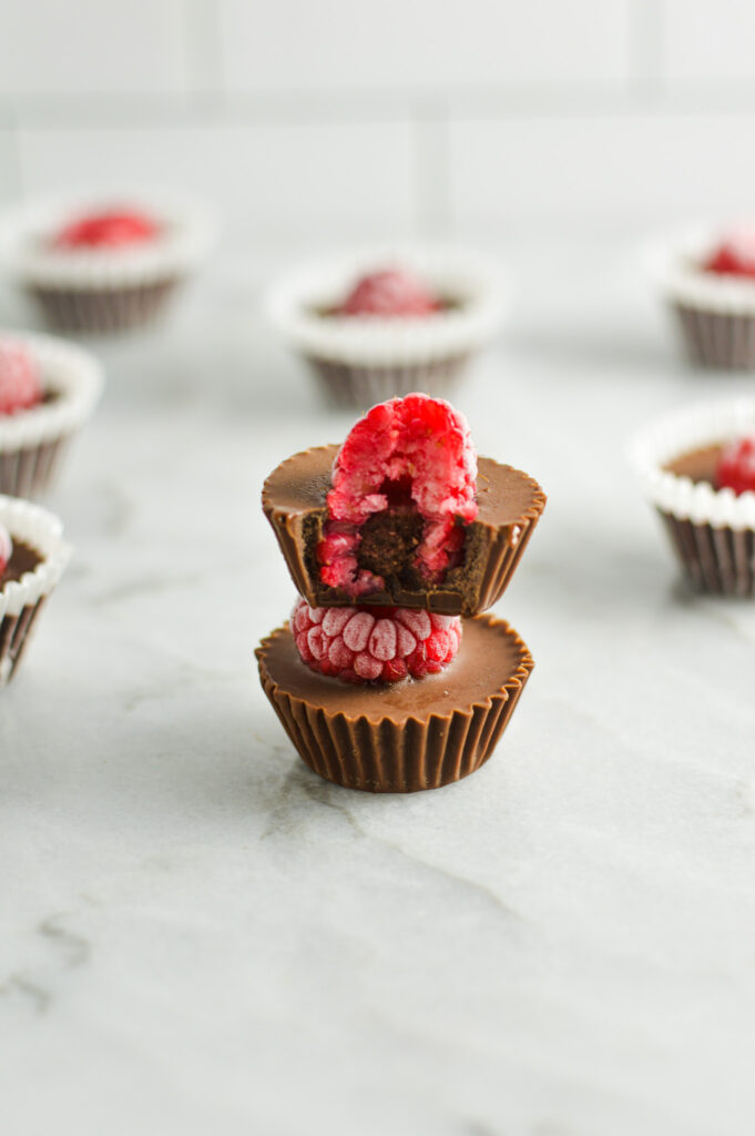 A stack of Raspberry Nutella Cups, with a bite taken out of the top, showing the creamy inside.