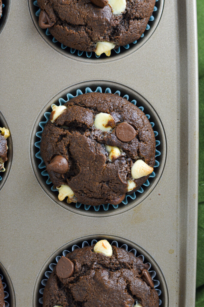 A standard sized muffin pan filled with freshly baked Triple Chocolate Banana Muffins.