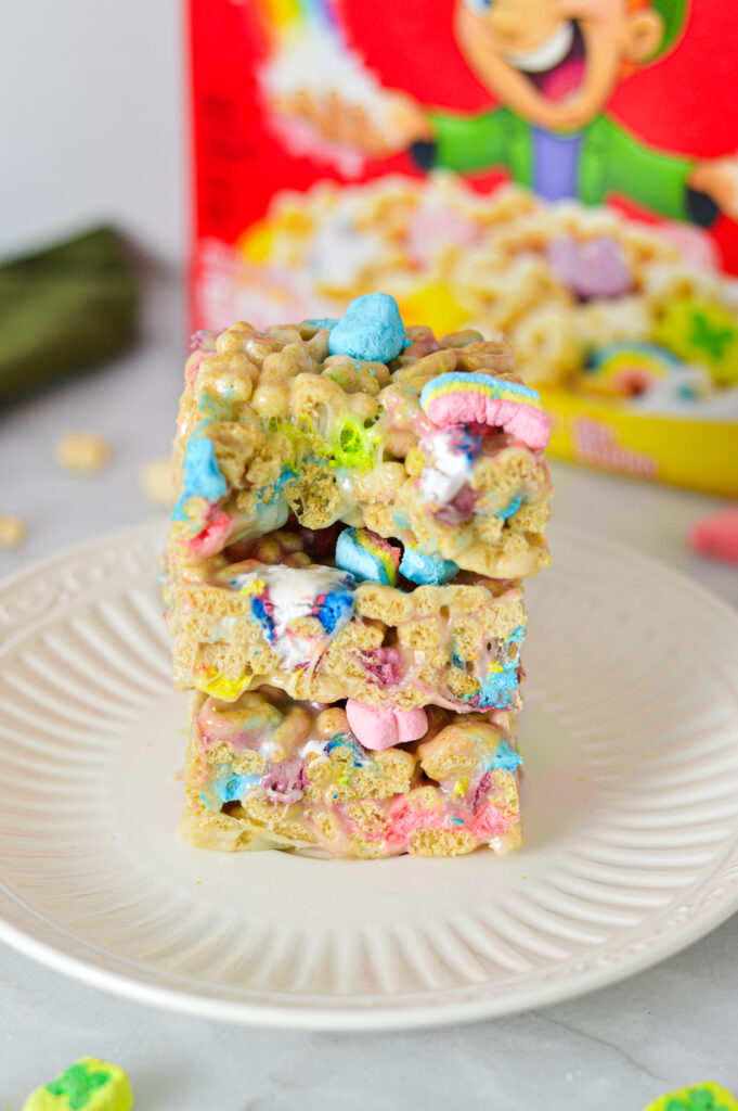 A stack of Lucky Charms Treats with a bite taken out of the top square showing the crunchy interior.